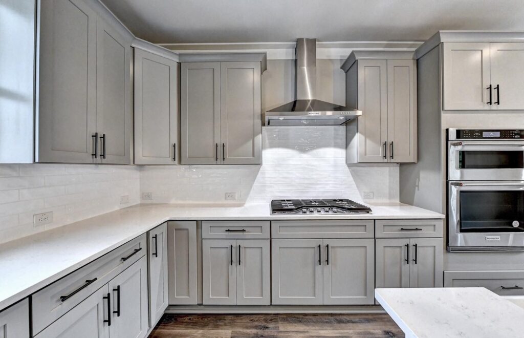 Modern white kitchen cabinets with sleek handles and ample storage space.