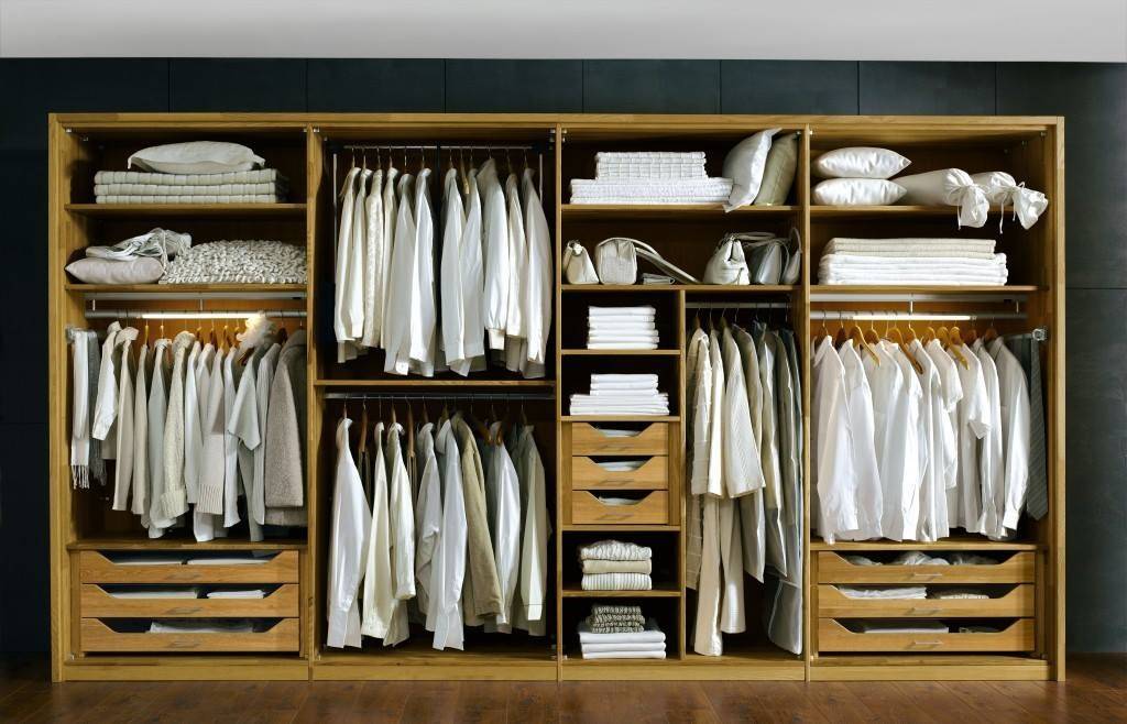 Customized clothes cabinets with hinged doors and organized shelving for bedroom storage